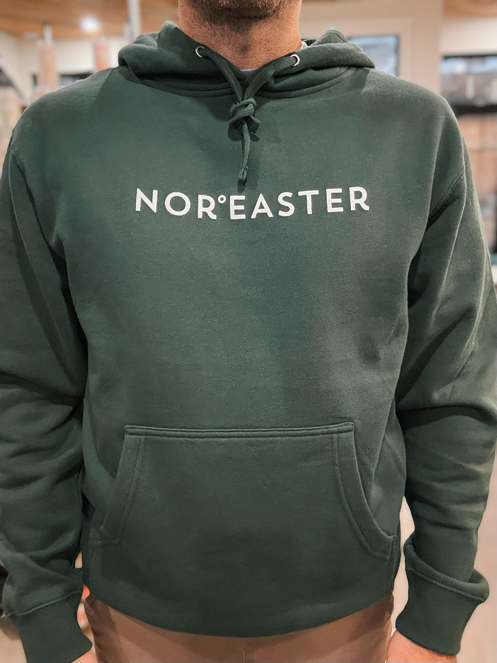 Alpine Green Nor'easter Apparel Hoodie with white ink, closeup view of a man in his mid-fourties