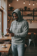 Shenanigans Coordinator Midweight Fleece Hoodie in grey with white ink on an african american man