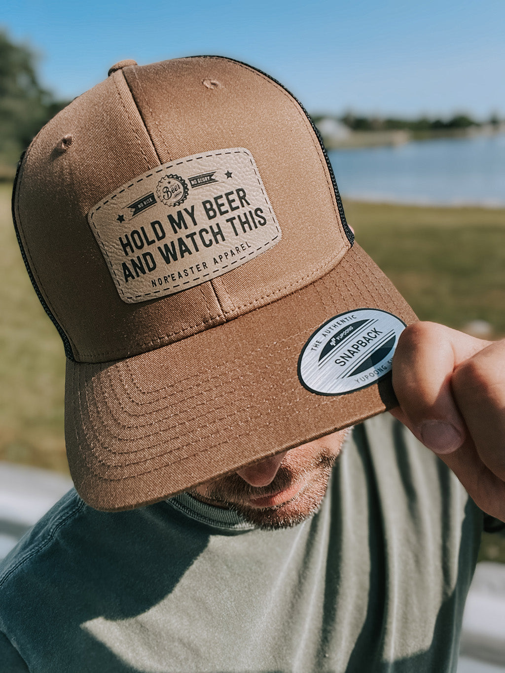 Nor'easter Apparel hold my beer hat in brown worn by a guy