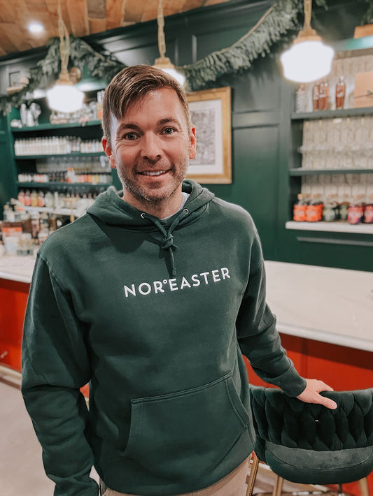 Alpine Green Nor'easter Apparel Hoodie with white ink, front on view of a man in his mid-fourties