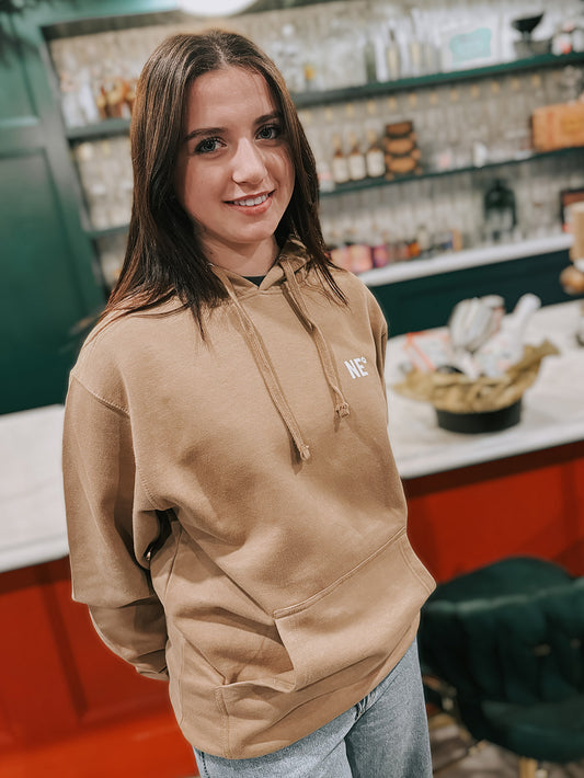 Nor'easter Apparel sandstone hoodie with white monogram on a young girl