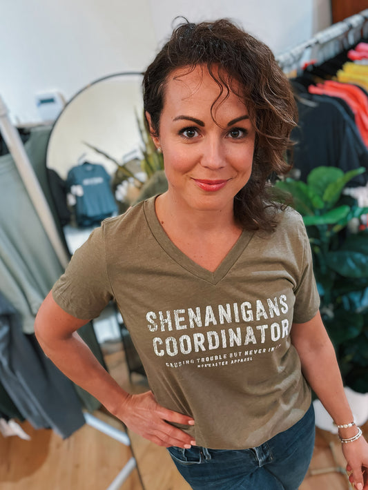 Women's vneck shenanigans coordinator in olive green with white text front view