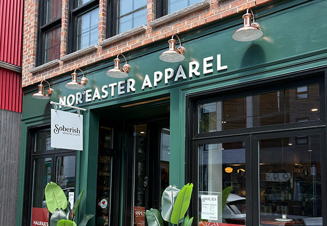 Nor'easter Apparel store front with 'Soberish' sign on a brick building.